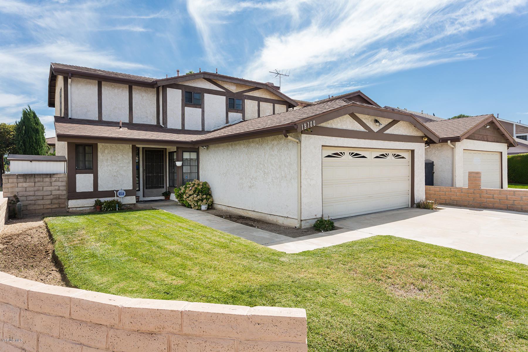 19700 Strathern Street Winnetka, CA 91306 - Photo 1 of 25 a front view of a house with a yard