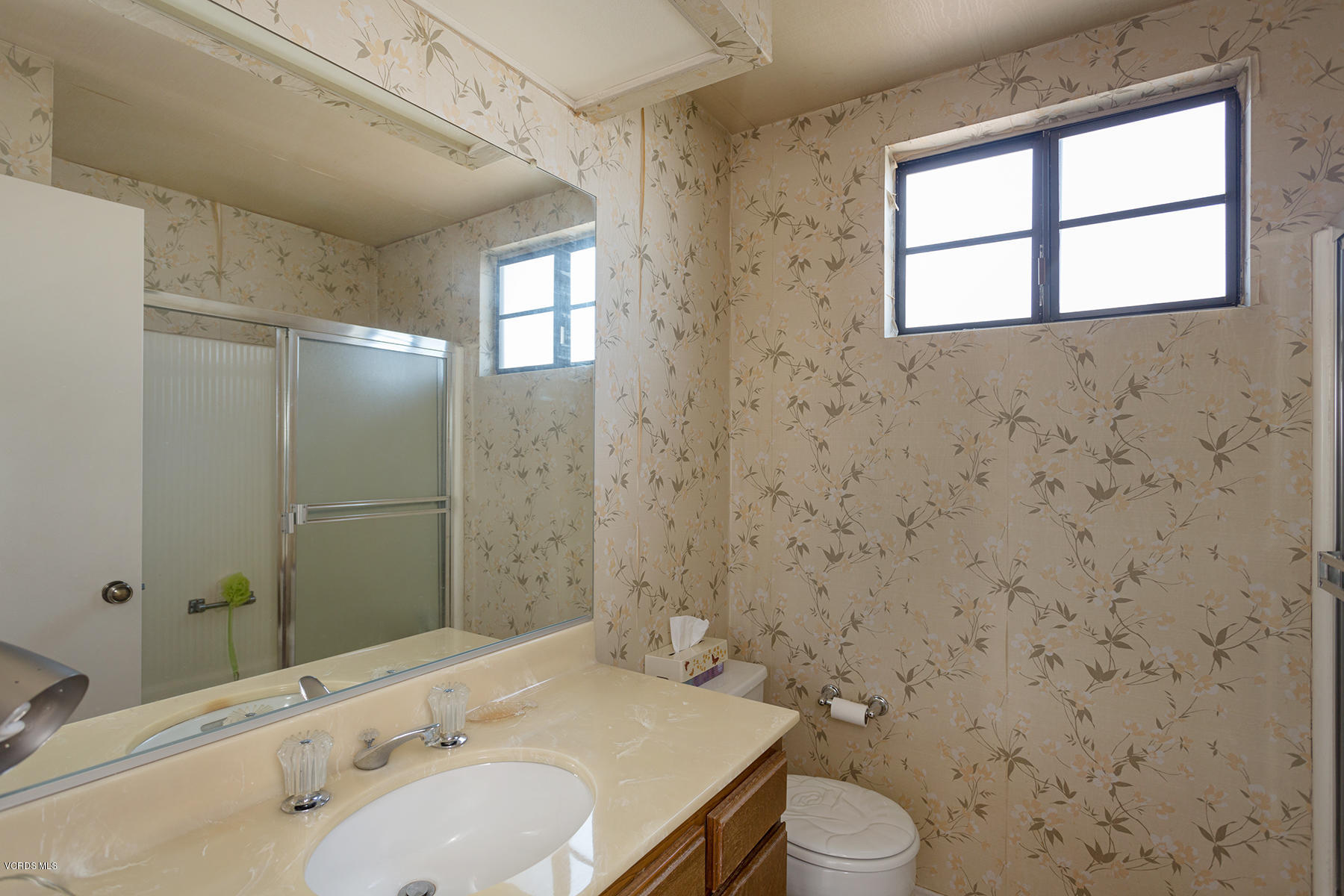 19700 Strathern Street Winnetka, CA 91306 - Photo 15 of 25 a bathroom with a sink a toilet and shower