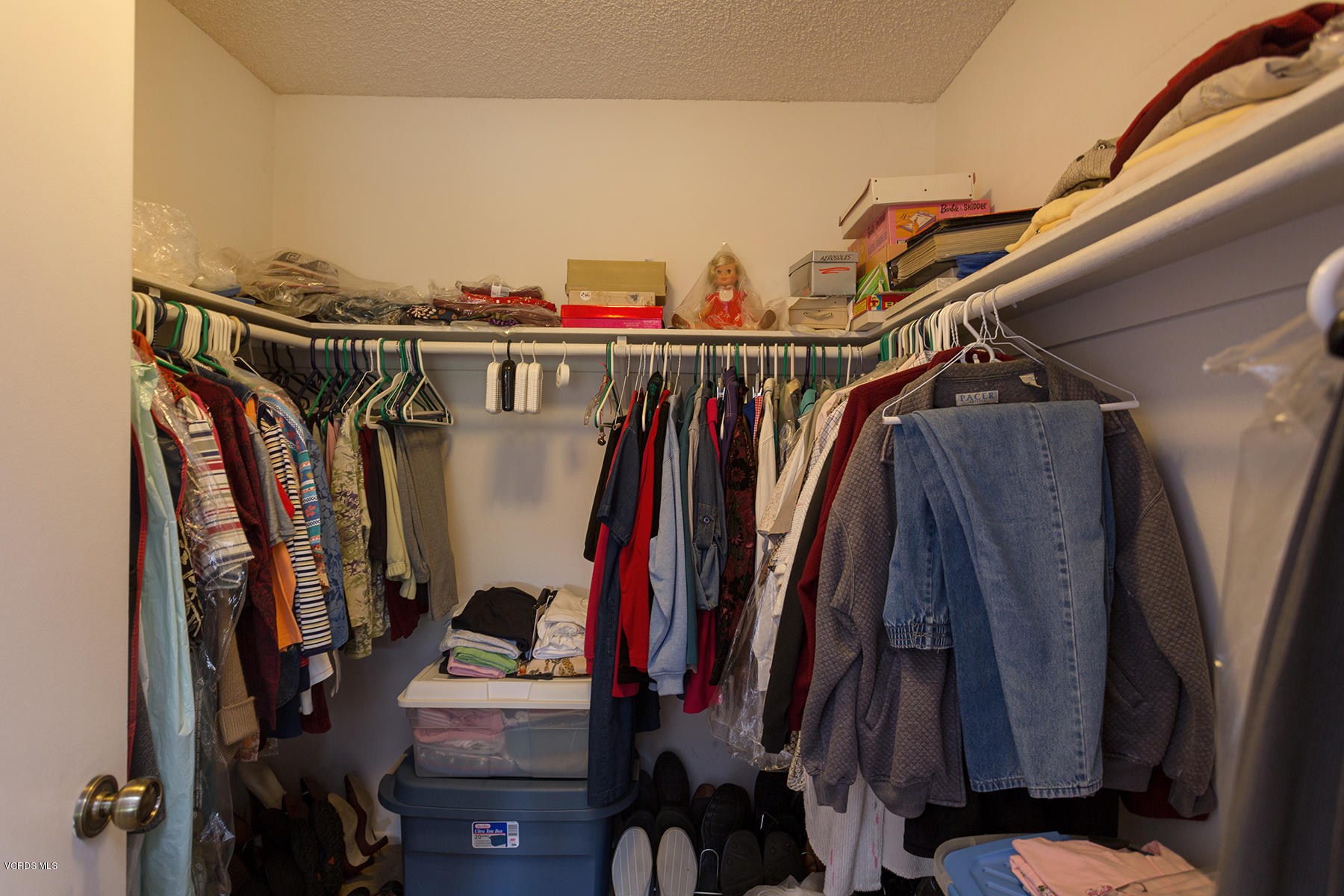 19700 Strathern Street Winnetka, CA 91306 - Photo 18 of 25 a view of walk in closet with clothes and shoes