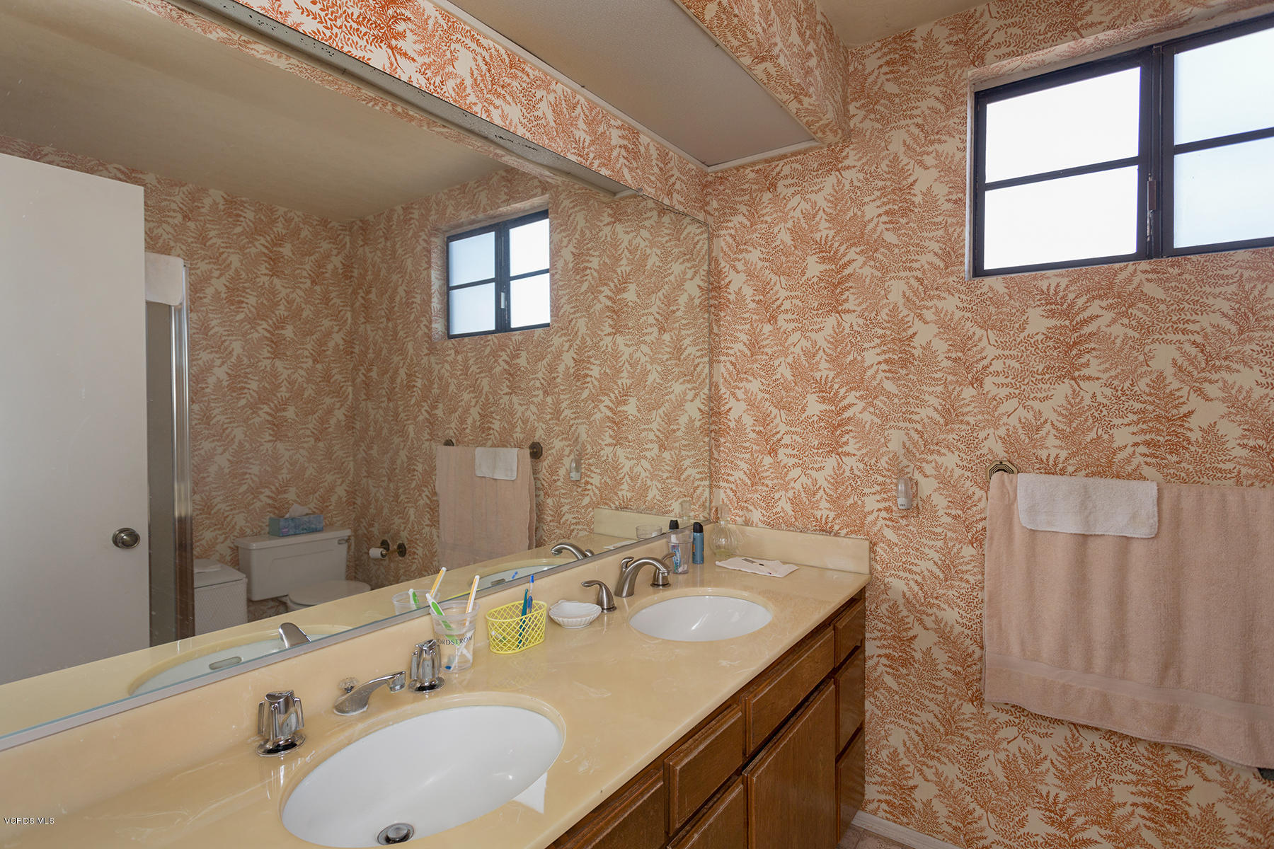 19700 Strathern Street Winnetka, CA 91306 - Photo 19 of 25 a bathroom with a granite countertop sink and a large mirror