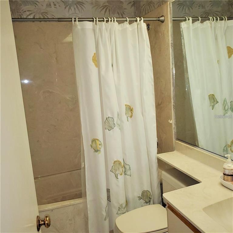 4538 Morningside, Unit 38 Sarasota, FL 34235 - Photo 9 of 13 a bathroom with a shower curtain and a sink