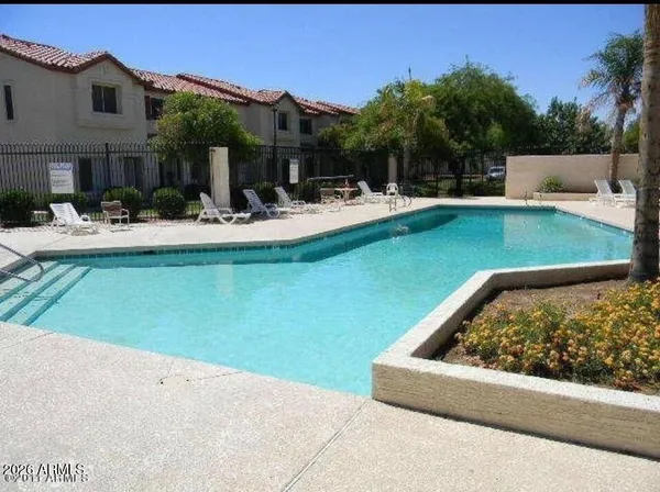 a view of swimming pool with outdoor seating and a yard