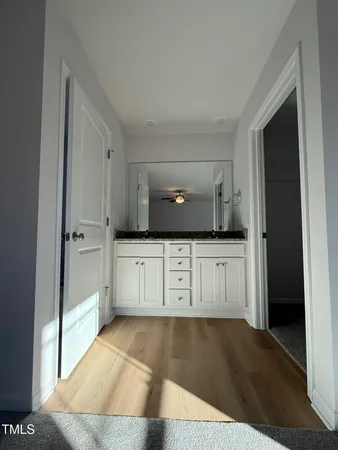 a view of a kitchen with white cabinets