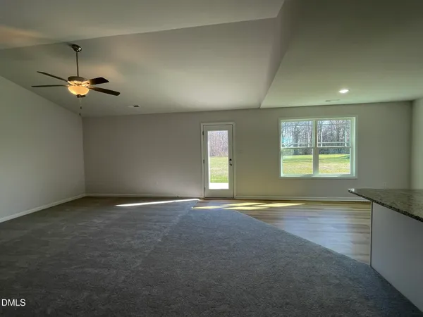 an empty room with a empty space and windows