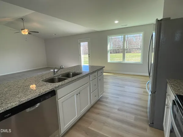 a bathroom with a double vanity sink and a window
