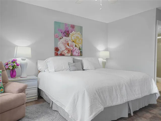 a bedroom with a bed and glass wall