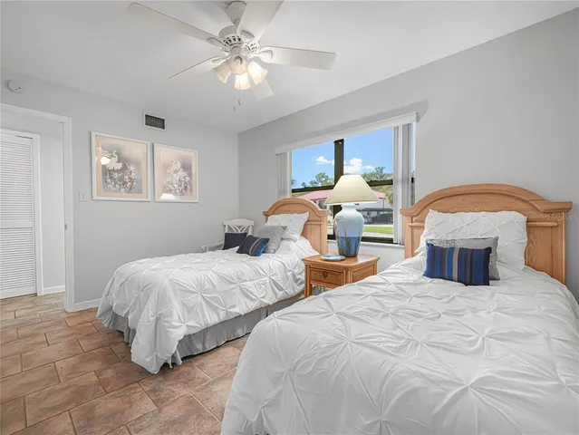 a bedroom with two beds and a chandelier
