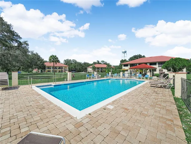 a view of a house with a big yard and a large tree