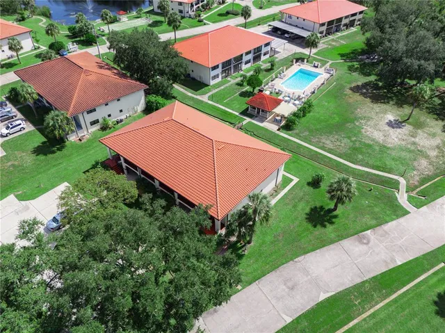 an aerial view of house with swimming pool outdoor seating and yard