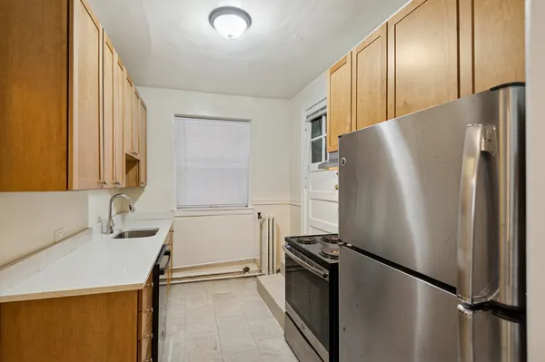 a kitchen with a refrigerator and a sink