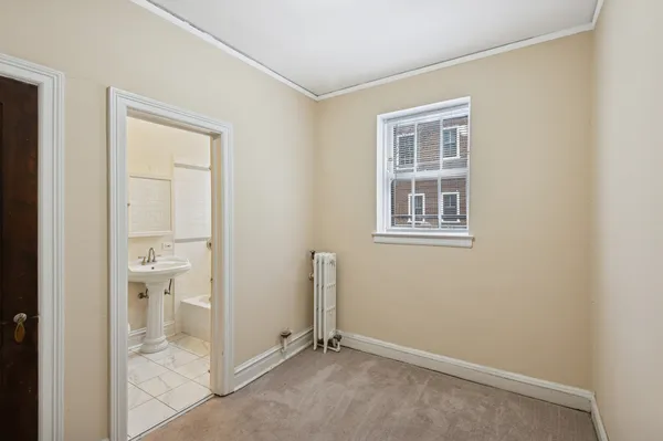 an empty room and a bathroom with a bathroom