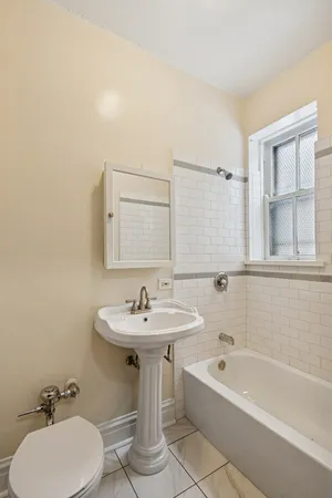 a bathroom with a sink a toilet and bathtub