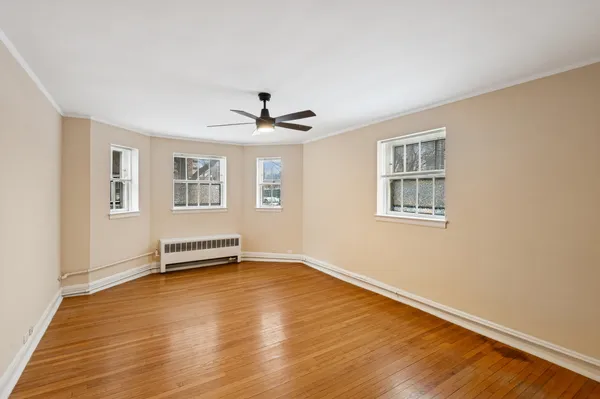 a view of a livingroom with wooden floor and a window