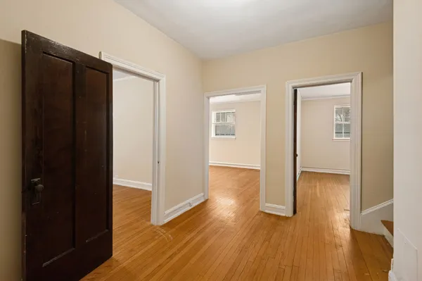 a view of a hallway with wooden floor
