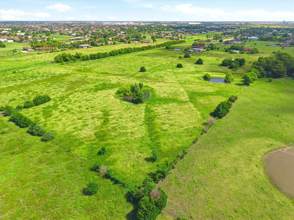 11749 Windy Lane Forney, TX 75126 - Photo 4 of 8 Expansive green landscape featuring varied terrain and multiple ponds