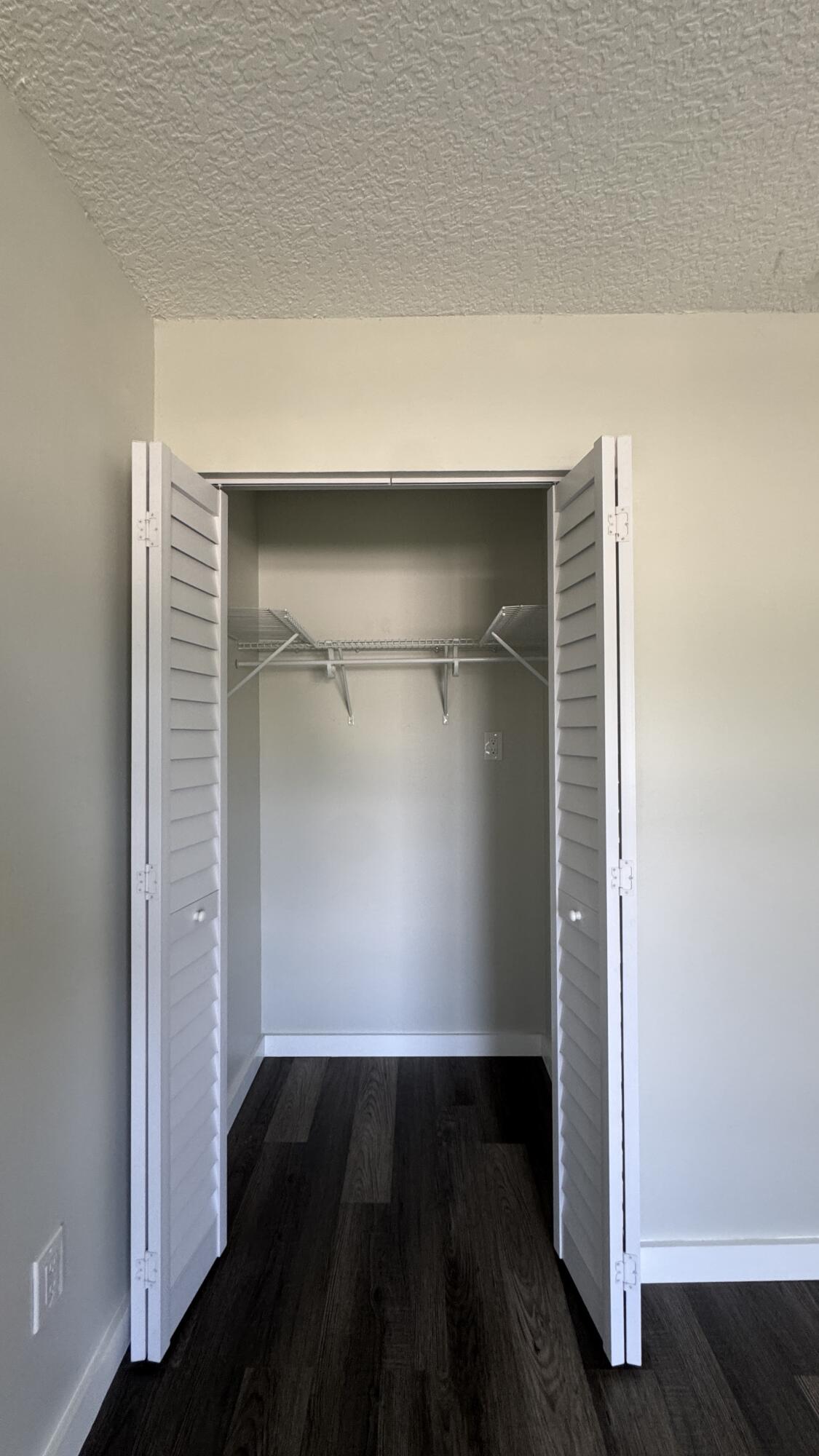 8395 Garden Gate Place Boca Raton, FL 33433 - Photo 12 of 35 an empty room with wooden floor and closet