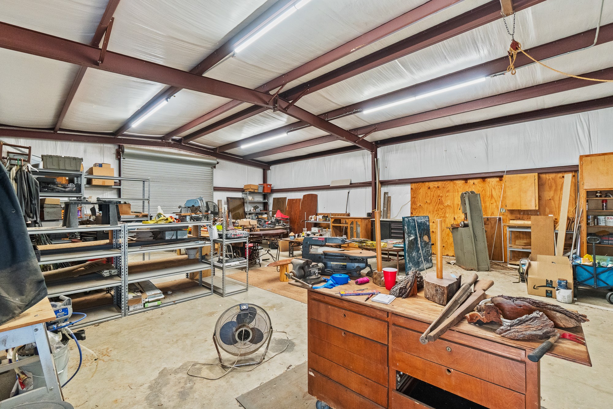 1951 Dowdy Road Seguin, TX 78155 - Photo 24 of 40 A spacious workshop features high ceilings with exposed metal beams and durable concrete flooring.