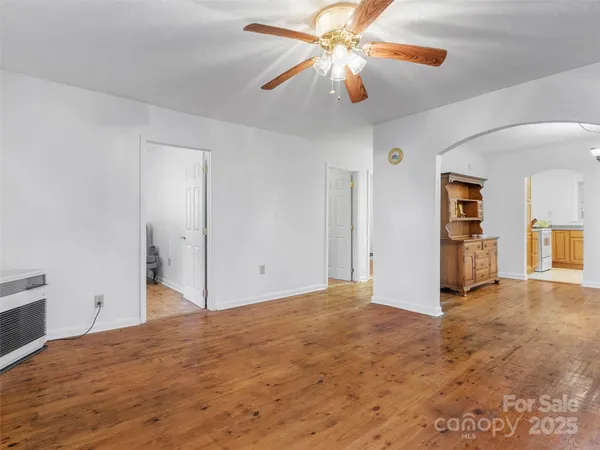 a view of a big room with closet and a ceiling fan