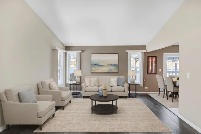 a living room with furniture wooden floor and a large window