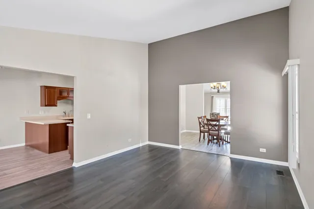 an empty room with wooden floor and furniture
