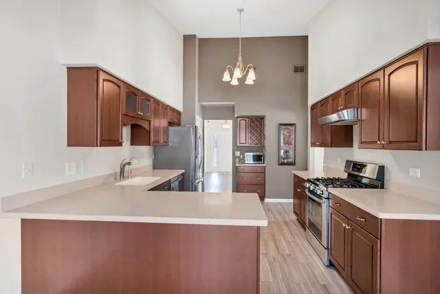 a kitchen with stainless steel appliances a sink stove and refrigerator