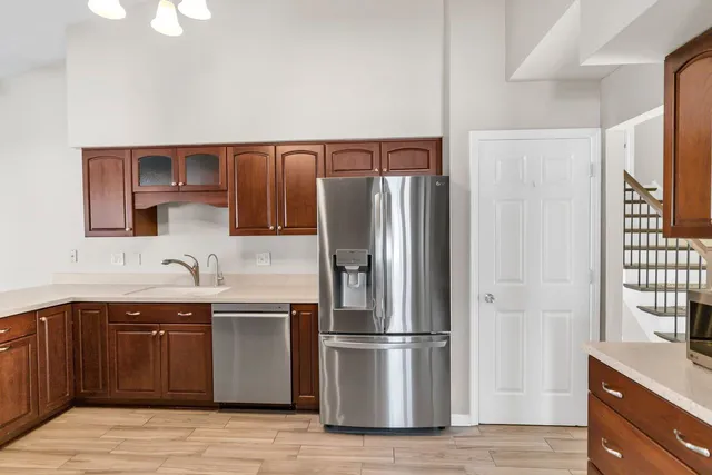 a kitchen with a refrigerator and a sink