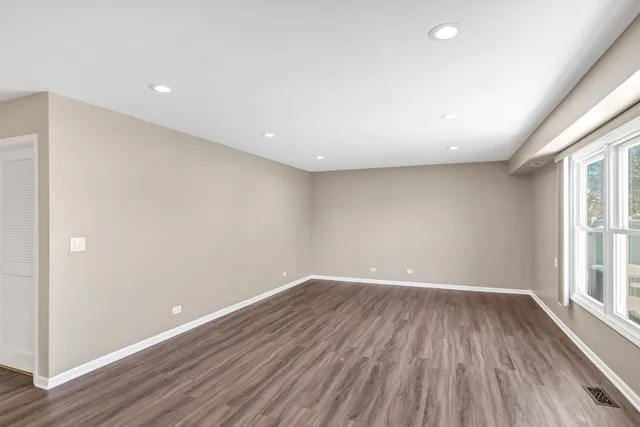 a view of room with window and wooden floor
