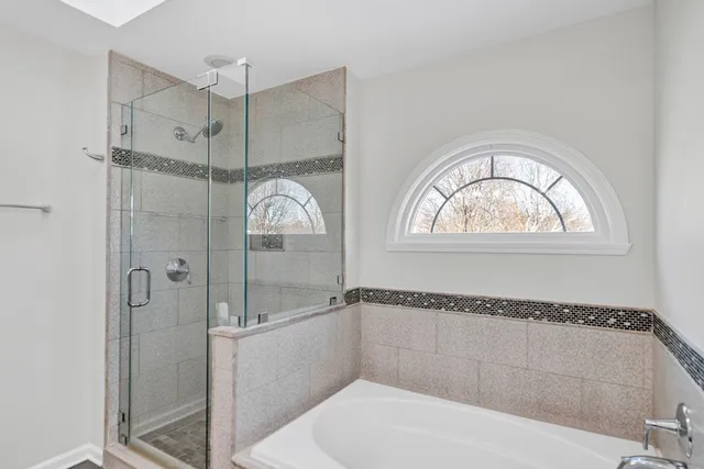 a bathroom with a tub and a shower