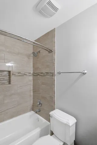 a bathroom with a toilet and a bathtub