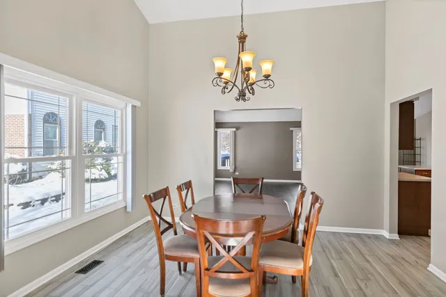 a view of a dining room with furniture wooden floor and chandelier