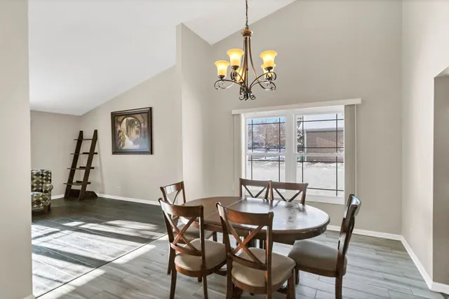 a view of a dining room with furniture wooden floor and chandelier