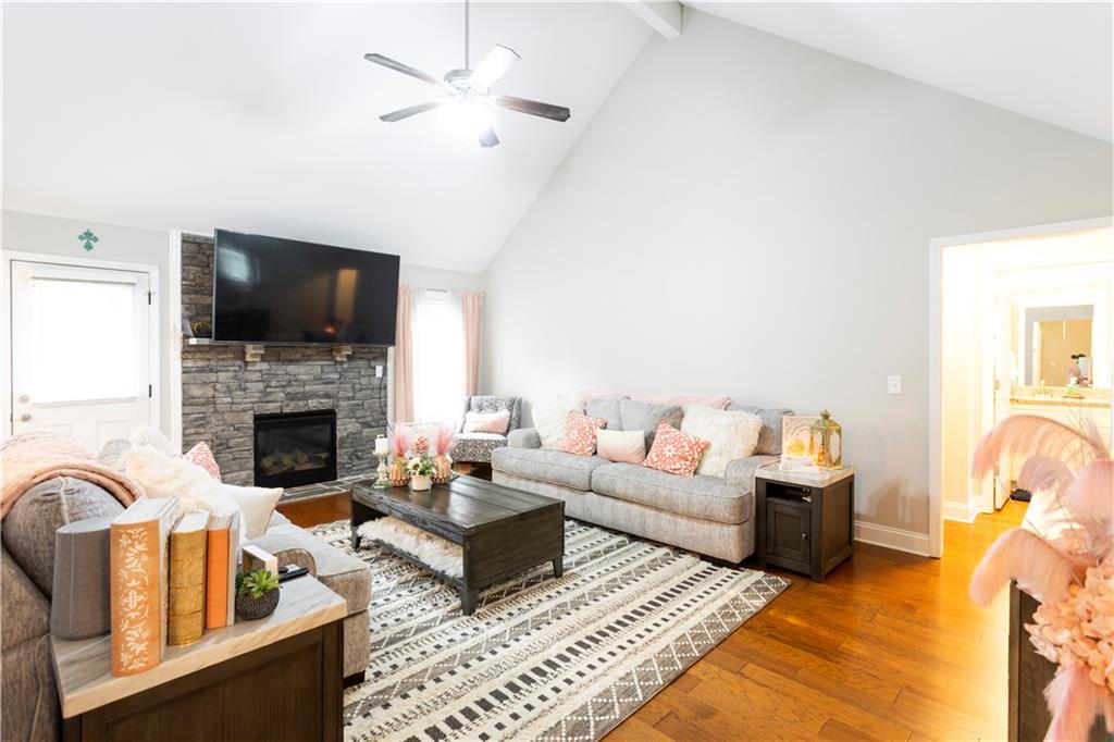 355 Conner Court Social Circle, GA 30025 - Photo 11 of 52 a living room with furniture a flat screen tv and a fireplace