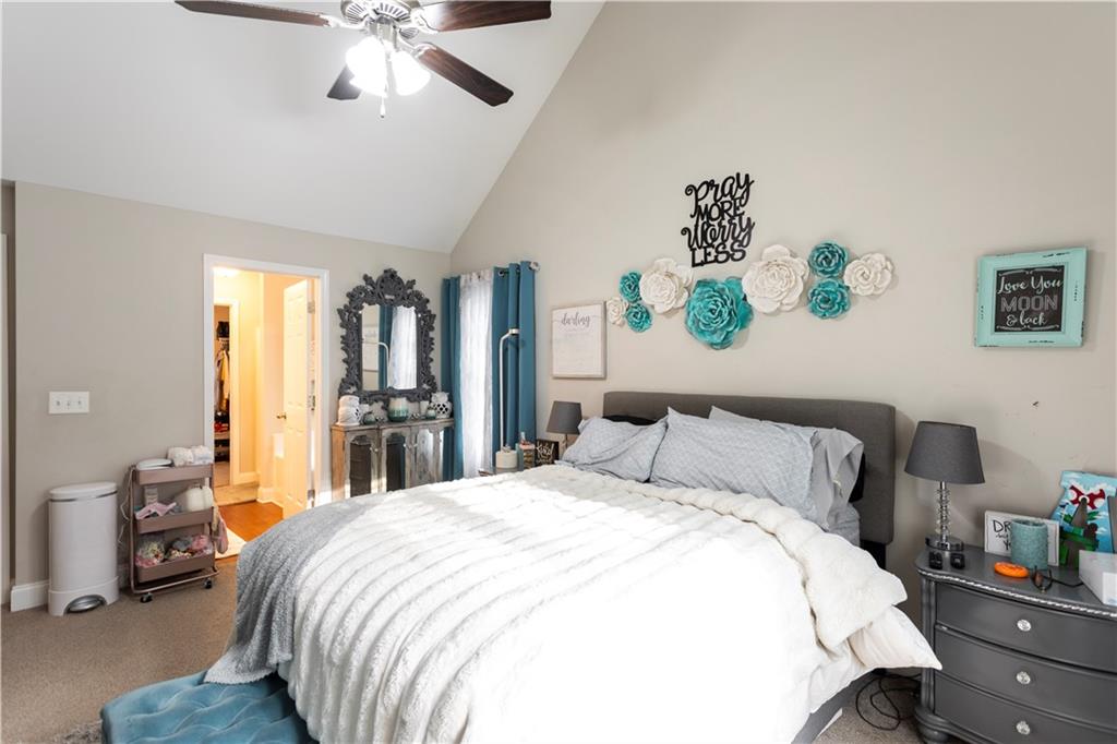 355 Conner Court Social Circle, GA 30025 - Photo 17 of 52 a bedroom with a bed and a chandelier