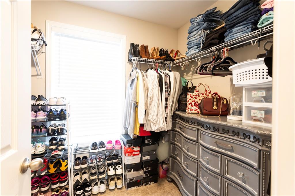 355 Conner Court Social Circle, GA 30025 - Photo 24 of 52 a view of walk in closet with clothes and shoes