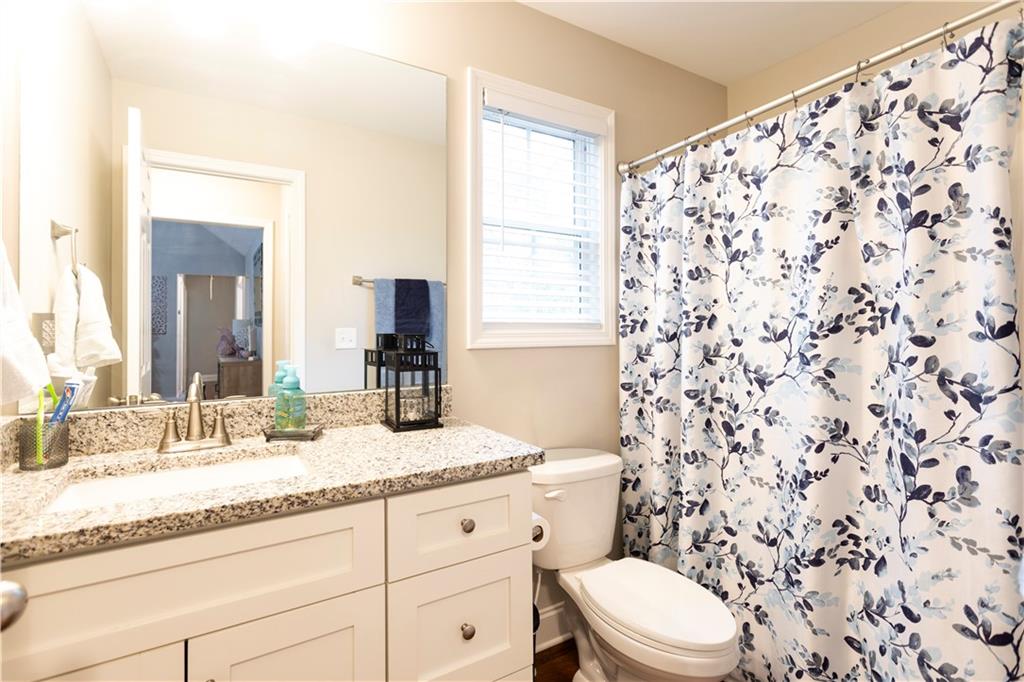 355 Conner Court Social Circle, GA 30025 - Photo 28 of 52 a bathroom with a granite countertop sink toilet mirror and shower