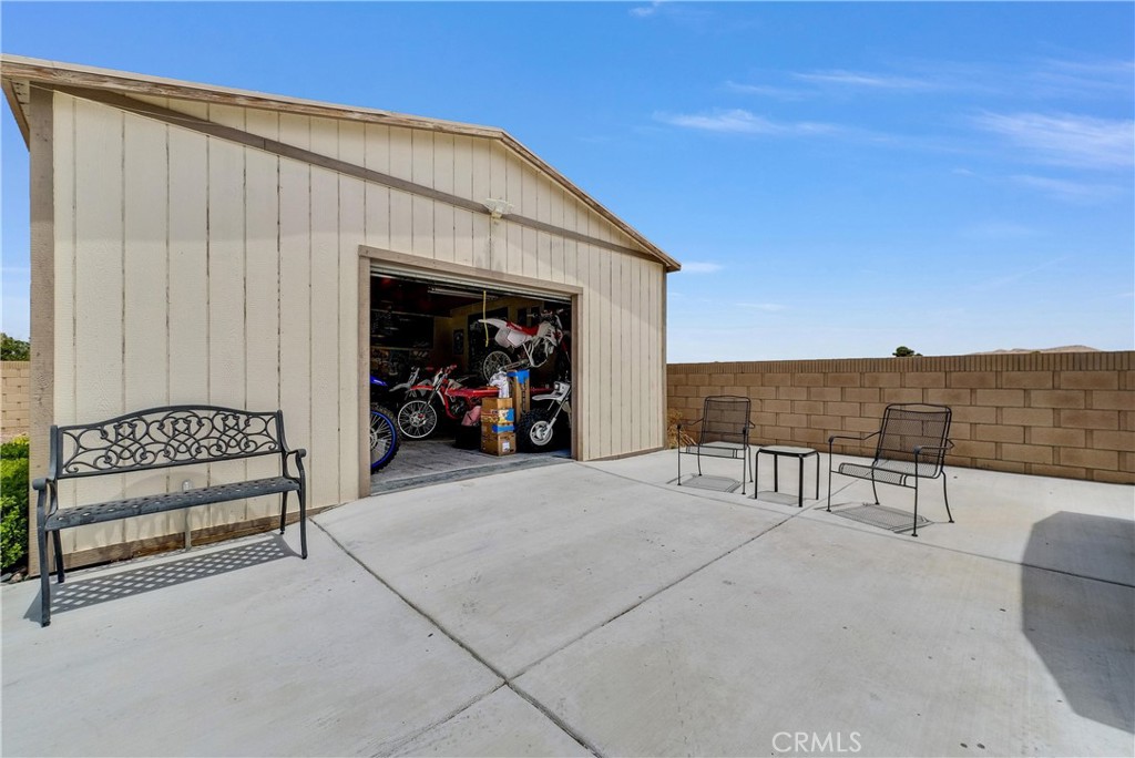 13931 Falling Leaf Road Apple Valley, CA 92307 - Photo 28 of 50 Work shop with Roll up door