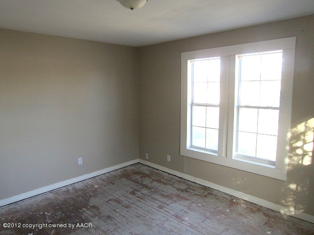 4216 South Harrison Street Amarillo, TX 79110 - Photo 11 of 14 an empty room with wooden floor and windows