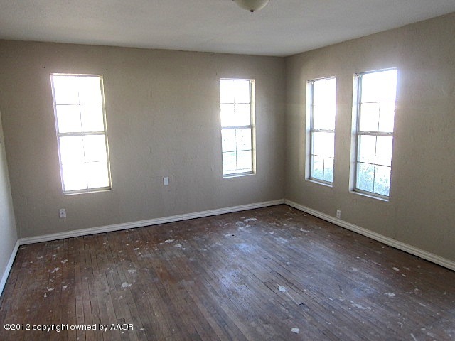 4216 South Harrison Street Amarillo, TX 79110 - Photo 12 of 14 a view of an empty room with wooden floor and window