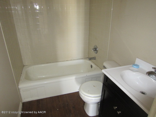 4216 South Harrison Street Amarillo, TX 79110 - Photo 8 of 14 a bathroom with a sink a toilet and bathtub
