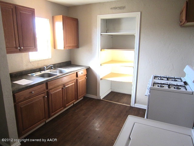 4216 South Harrison Street Amarillo, TX 79110 - Photo 9 of 14 a kitchen with a cabinets and white appliances