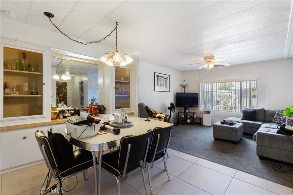 300 North Rampart Street, Unit 195 Orange, CA 92868 - Photo 9 of 25 a view of a dining room and livingroom with furniture window and wooden floor