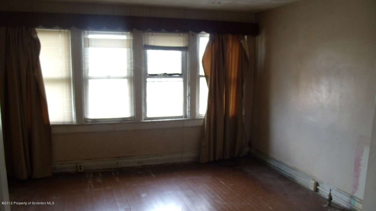 122 East Mountain Road Scranton, PA 18505 - Photo 6 of 12 a view of an empty room with wooden floor and a window