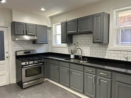 a kitchen with granite countertop cabinets stainless steel appliances and a sink