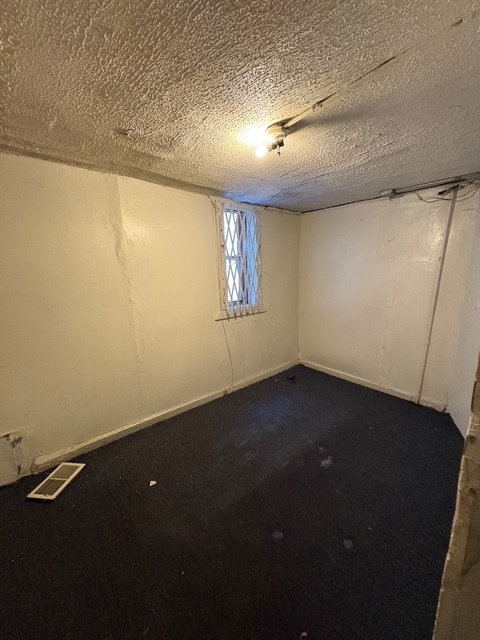 6408 South Rhodes Avenue Chicago, IL 60637 - Photo 7 of 19 an empty room with a window
