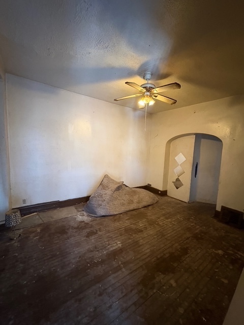 6408 South Rhodes Avenue Chicago, IL 60637 - Photo 8 of 19 a view of a room with wooden floor and a ceiling fan