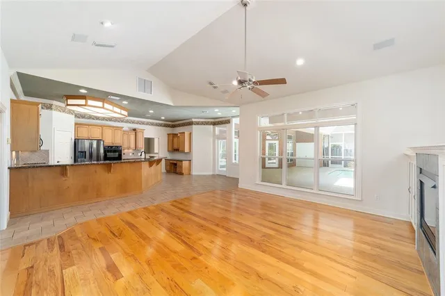 a view of a kitchen with furniture and floor to ceiling windows