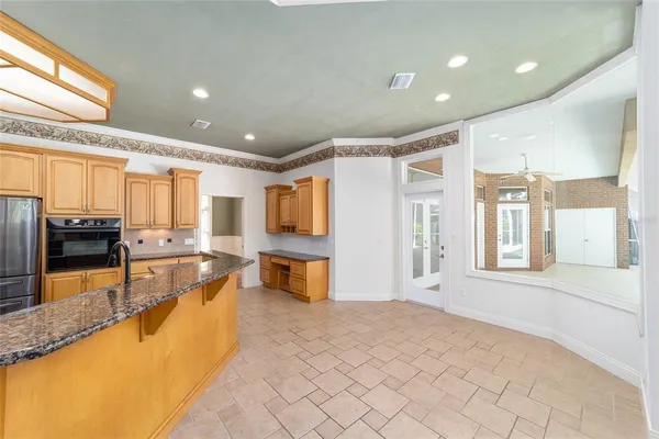 a kitchen with stainless steel appliances granite countertop sink stove and granite counter top