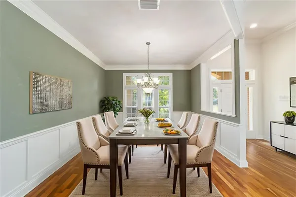 a view of a dining room with furniture window and wooden floor