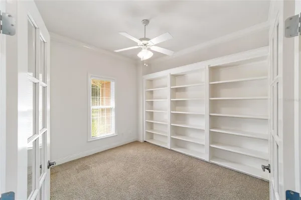a view of a hallway with wooden floor and a bathroom