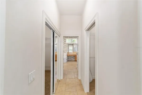 a bathroom with a granite countertop double vanity sink a mirror and a bathtub